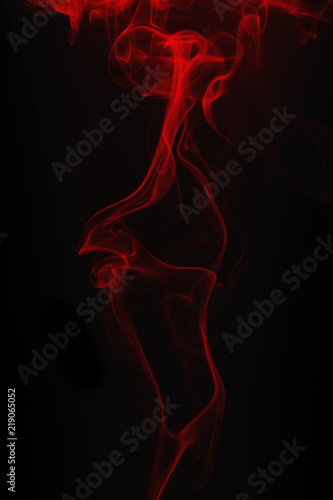 Movement of red smoke on black background