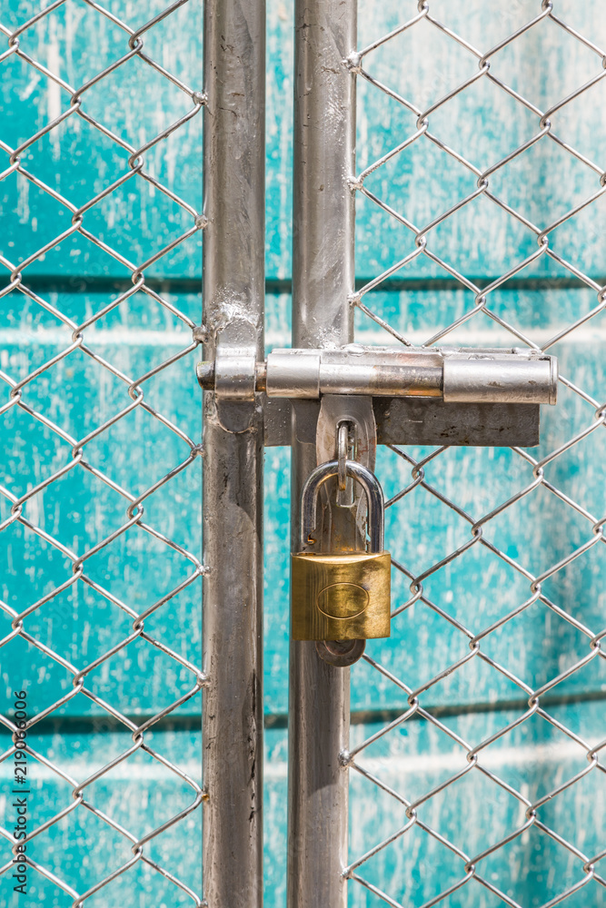metal fence is unlock with a gold keychain metal fence is unlock with a gold keychain