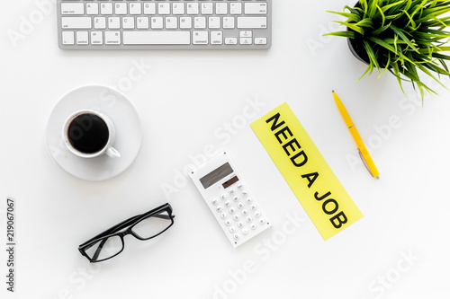 Need a job sign on office desk with computer keyboard on white background top view. Unemployment concept