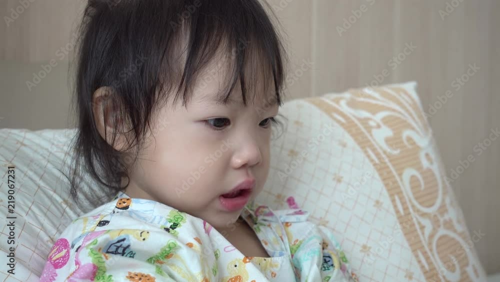 Baby girl using baby nasal aspirator, She is doing a mucus suction. Baby girl using baby nasal aspirator, She is doing a mucus suction.