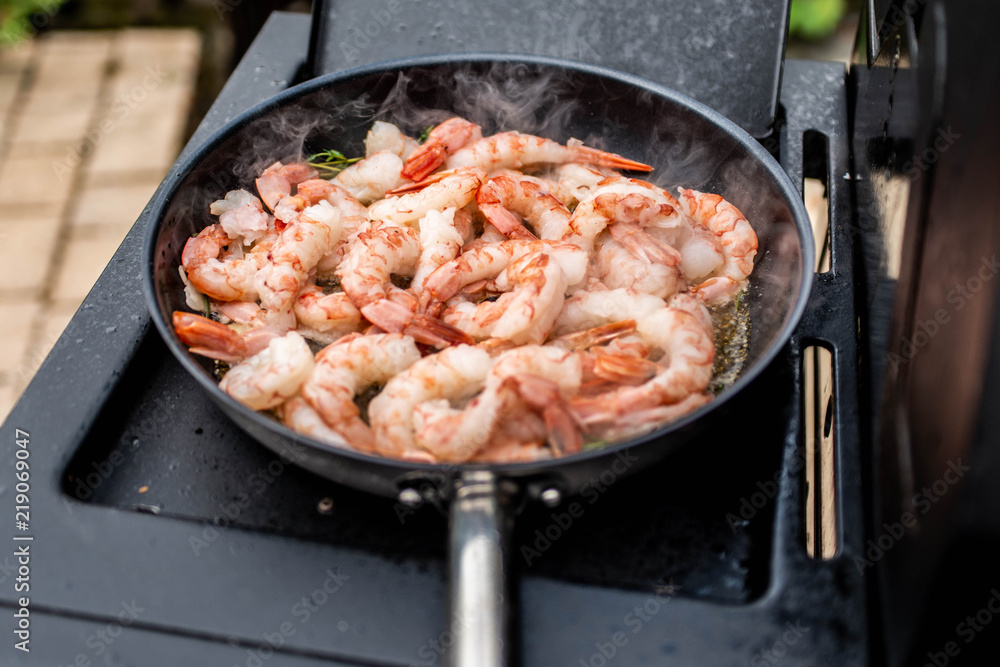 Spicy shrimps on pan with garlic, coriander and peppers Spicy shrimps on pan with garlic, coriander and peppers