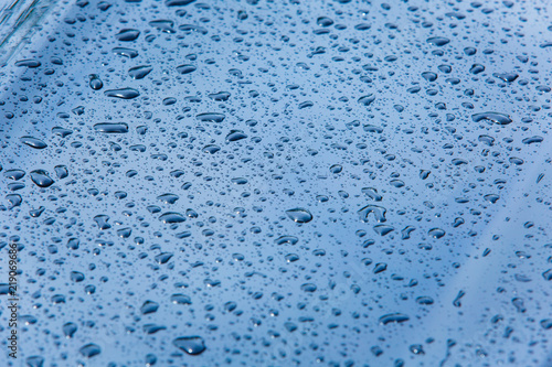Dark metal surface covered in water drops close-up