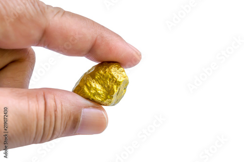 hand holding a pure gold nugget isolated on white background with clipping path
