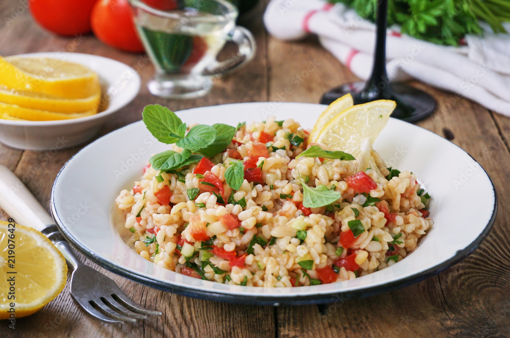 Salad with bulgur, tomatoes, cucumbers and fresh herbs Salad with bulgur, tomatoes, cucumbers and fresh herbs