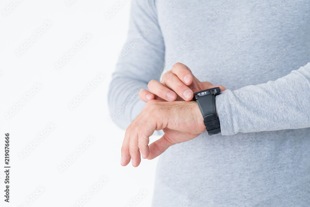 fitness tracker is a useful gadget in everyday life. man checking his heart rate or distance he walked on his hand watch. fitness tracker is a useful gadget in everyday life. man checking his heart rate or distance he walked on his hand watch.