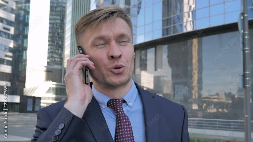 Businessman Discussing on Phone, Standing Outside Office Businessman Discussing on Phone, Standing Outside Office