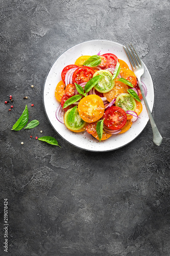 Tomato salad. Fresh vegetable salad with tomatoes, onion and basil