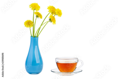 Cup of herbal tea and dandelion flowers