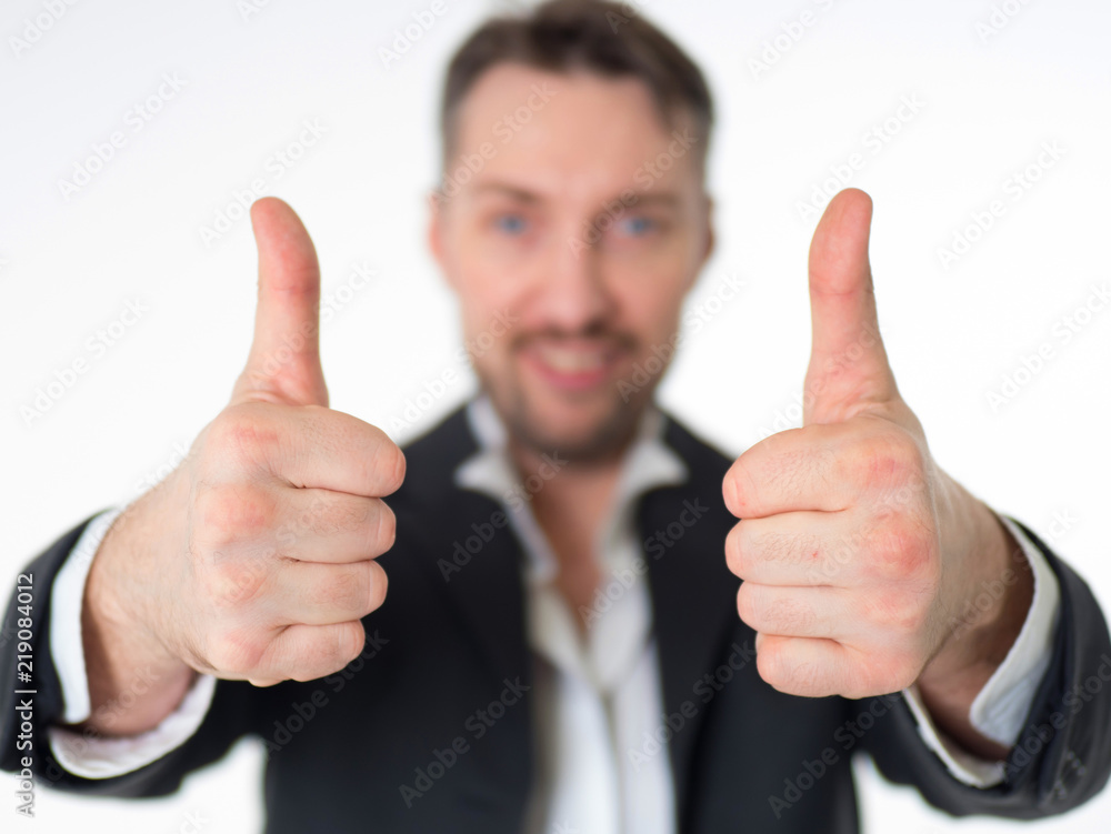 Happy smiling businessman with thumbs up gesture, isolated on white background. Focus on the hands. Happy smiling businessman with thumbs up gesture, isolated on white background. Focus on the hands.