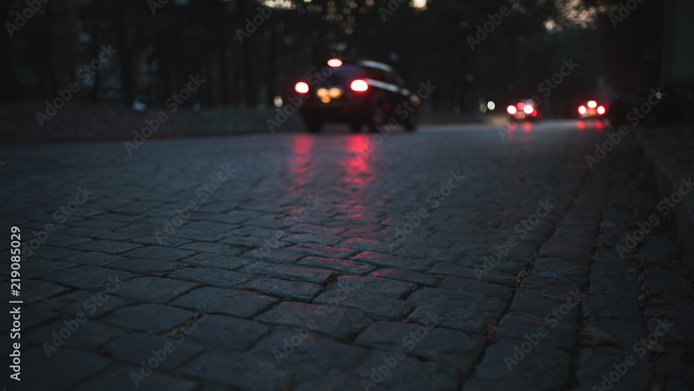 Road tiles, cars ride at night
