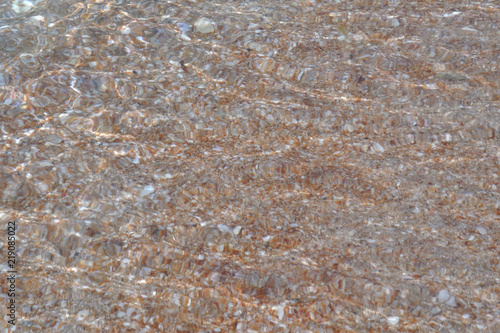 Tide waves on the beach with shells and sand