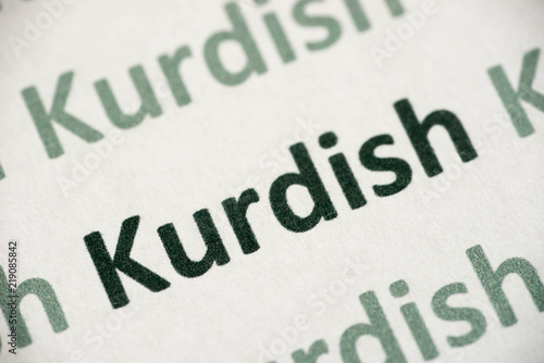 word Kurdish language printed on paper macro