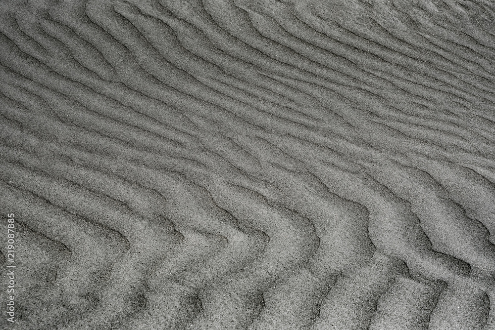 Top view of sandy. Background wiht copy space and visible sand texture. Fine sand. Pattern on the sand. Top view of sandy. Background wiht copy space and visible sand texture. Fine sand. Pattern on the sand.