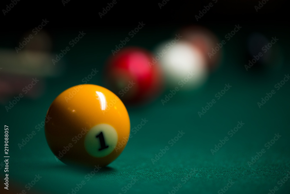 Sport billiard balls on green billiard table in pub. On going billiard game. Competitive players trying to find out the winner of the round Sport billiard balls on green billiard table in pub. On going billiard game. Competitive players trying to find out the winner of the round