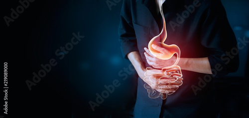 Working man touching stomach, suffering painful of stomachache, gastrointestinal system disease during working, cause of stress from work, Healthcare and insurance concept photo