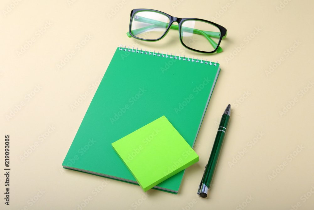 Business accessories on desktop: notebook, diary, fountain pen, glasses. Macro with blur and soft focus. Business accessories on desktop: notebook, diary, fountain pen, glasses. Macro with blur and soft focus.