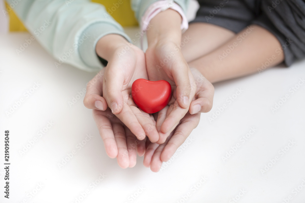 Tow child holding red heart, closeup. Adoption concept Tow child holding red heart, closeup. Adoption concept