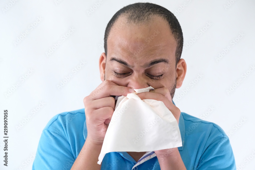 Man in blue t-shirt expressive face sniff Man in blue t-shirt expressive face sniff