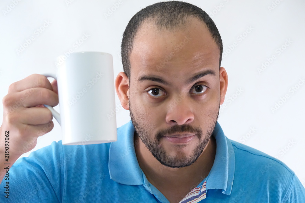 Man in blue t-shirt expressive face mug of coffee Man in blue t-shirt expressive face mug of coffee
