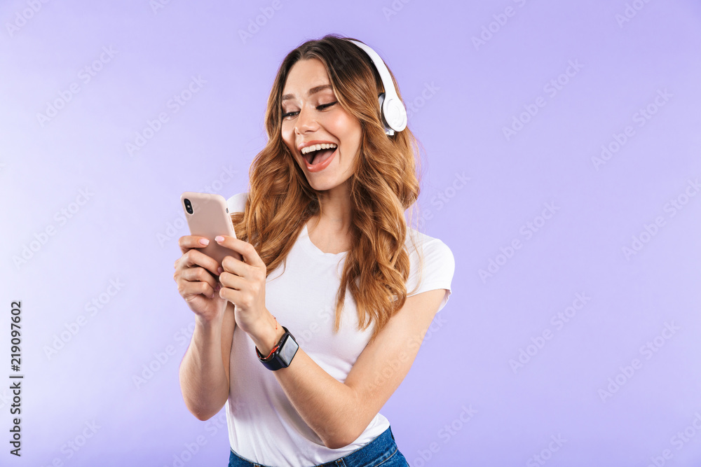Portrait of a happy young girl holding mobile phone Portrait of a happy young girl holding mobile phone