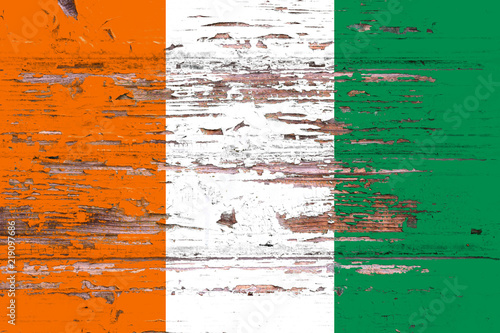 National flag of cote d'Ivoire on a dull wooden background © Виталий Сова