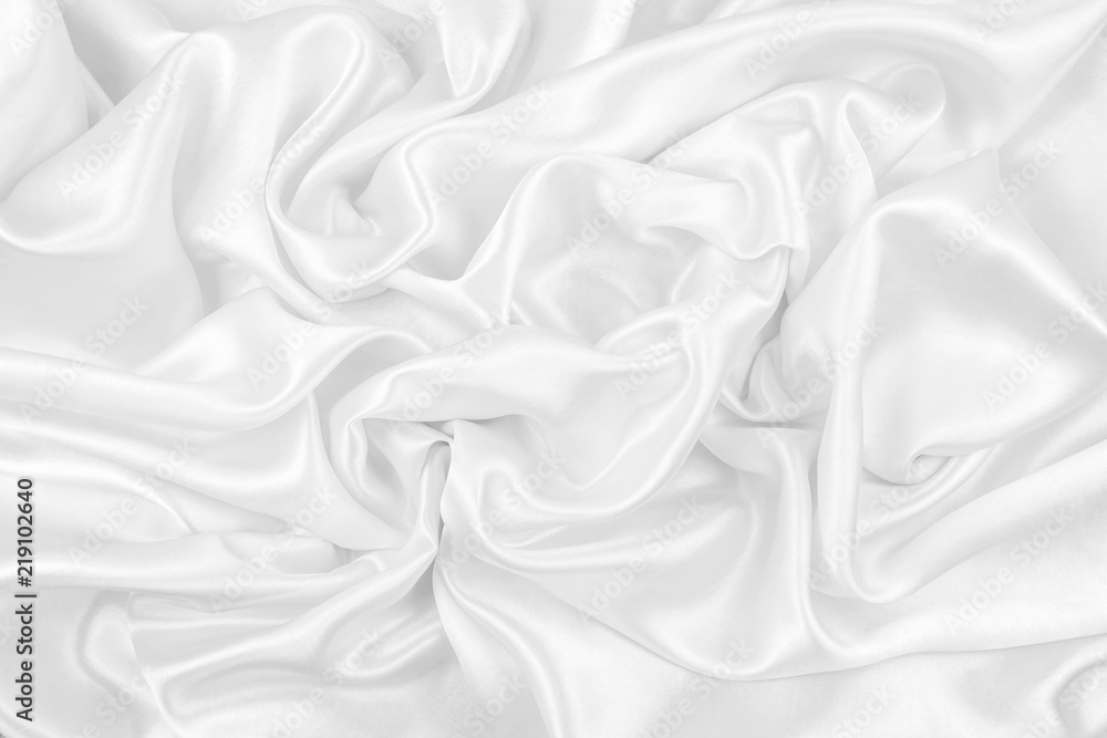 Luxurious of smooth white silk or satin fabric texture background Luxurious of smooth white silk or satin fabric texture background