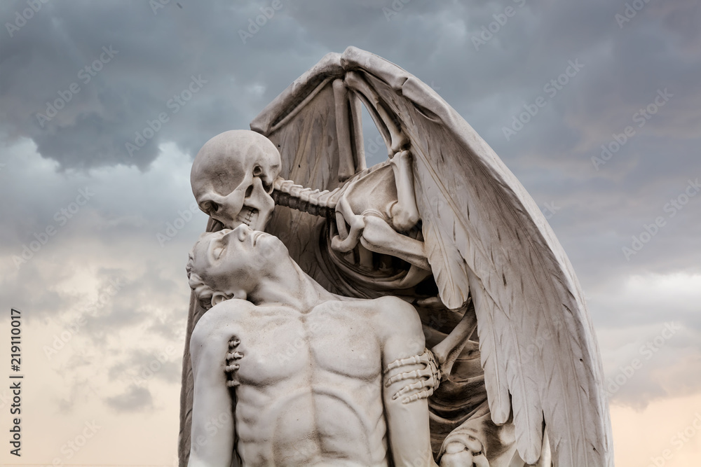 The Kiss of Death statue in Poblenou Cemetery in Barcelona. This marble  sculpture depicts death, as