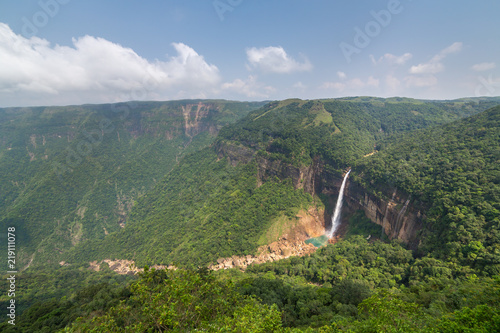 Nohkalikai waterfall surrounded by high cliffs and woodland and thick vegetation near Cherrapunji, Meghalaya, India. photo