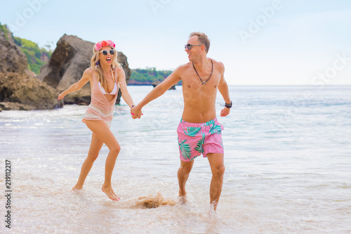 Couple running in the ocean