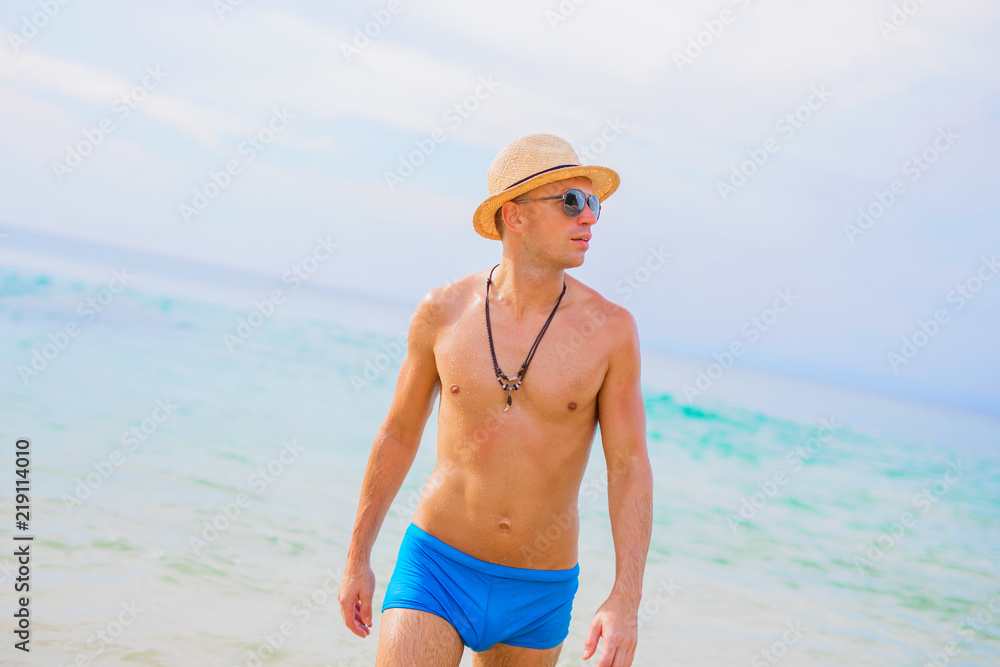 Handsome shirtless man on beach