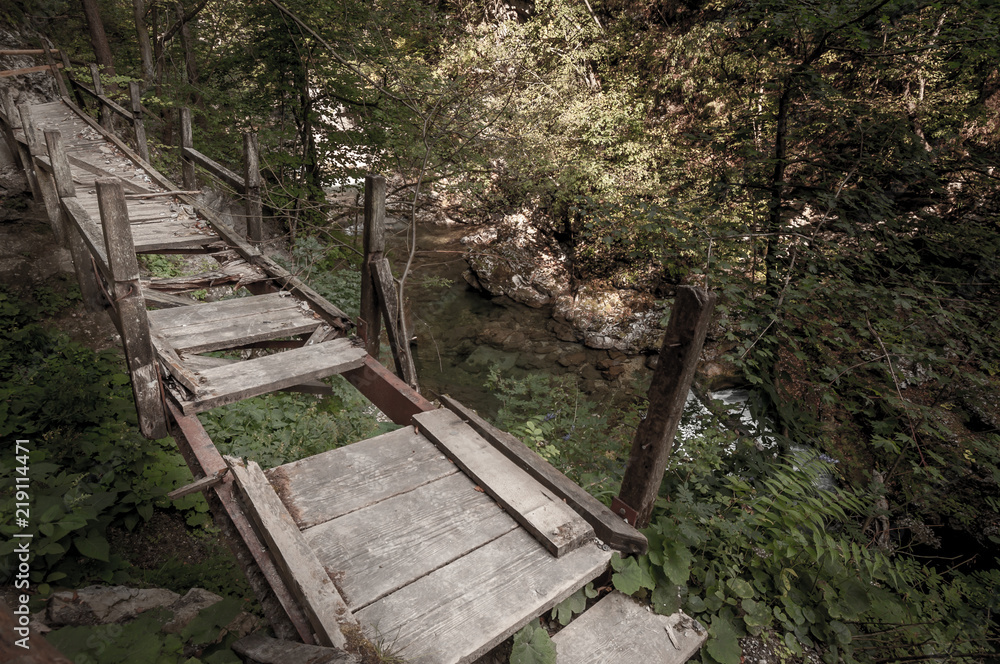 Broken walking bridge over the river Broken walking bridge over the river