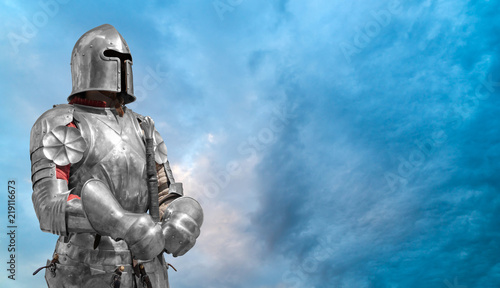 Knight in helmet and metal armor.