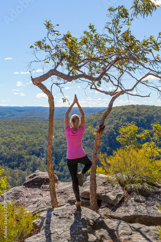 Female yoga asanas in mountain wilderness views photo