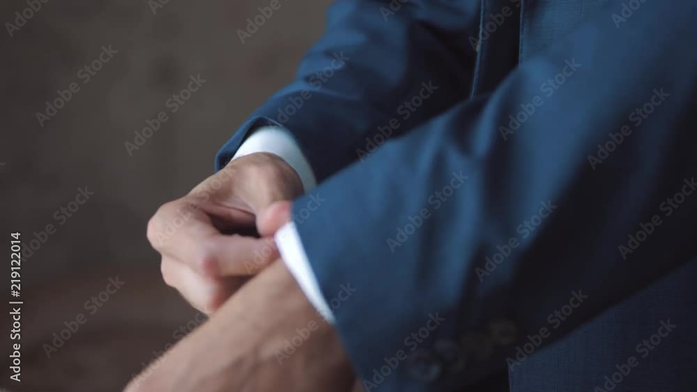 A young man fastens suit. A young man fastens suit.