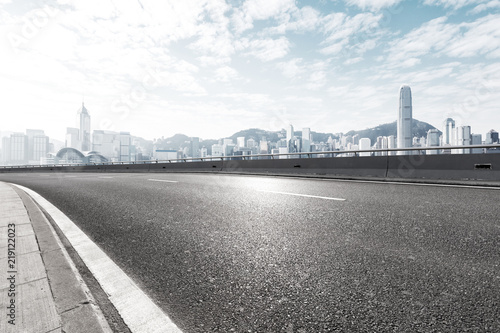 Canvas Print empty asphalt highway street with city skyline