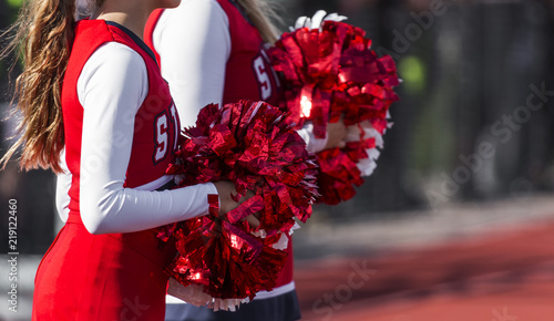 Foto Two cheerleaders with red and white pom poms