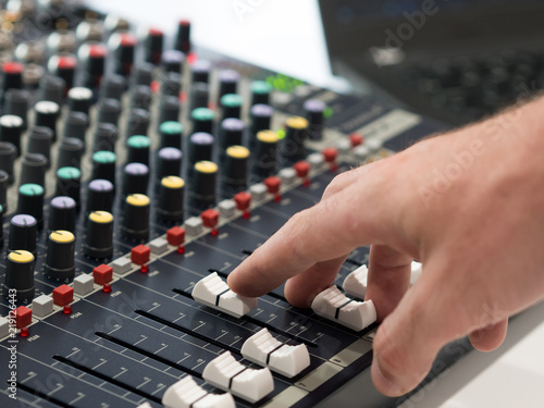 Audio engineer working on mixing console