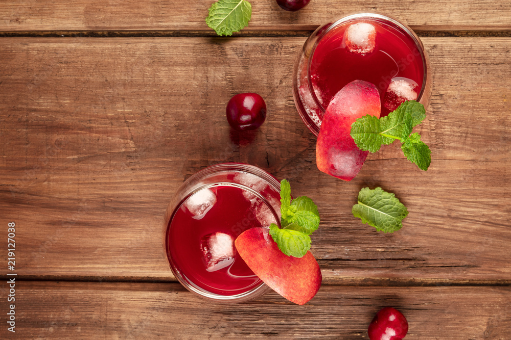 Overhead photo of vibrant red drink with berries on a rustic background Overhead photo of vibrant red drink with berries on a rustic background