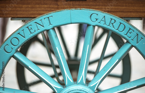 Covent Garden written on the famous flower cart wheel, welcoming tourists photo