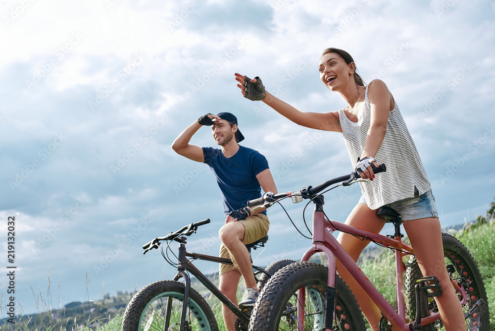 A happy couple on mountain bikes opens up new horizons. A happy couple on mountain bikes opens up new horizons.