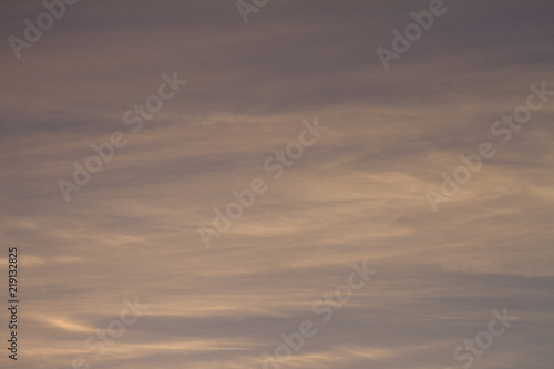 Sky clouds background. Cumulus clouds in the sunset. Color clouds in the evening. Sky with a pastel colored background