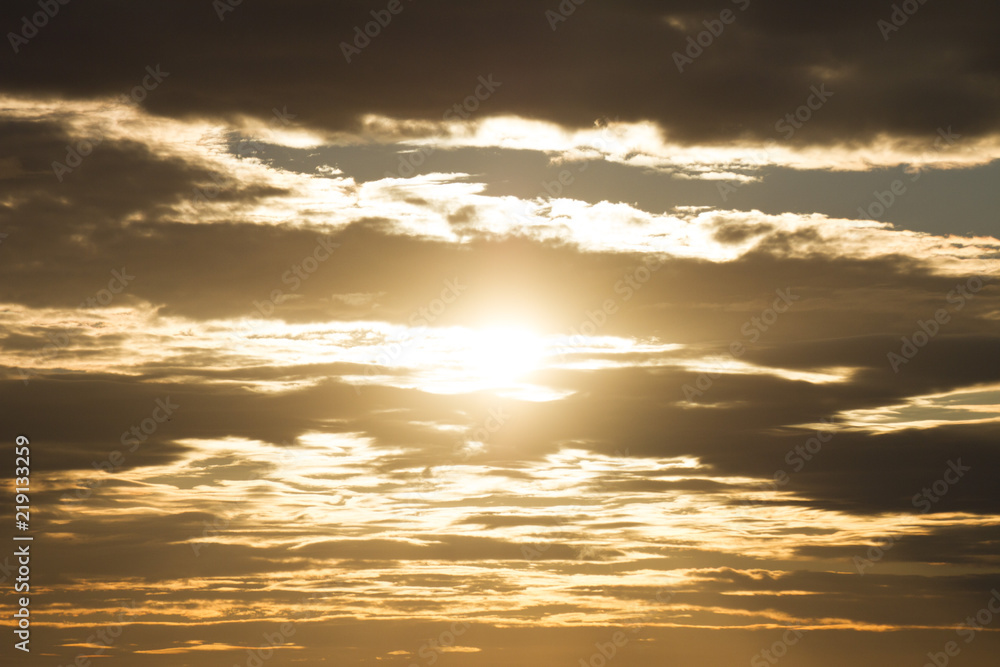 Sky clouds background. Cumulus orange clouds in the sunset. Color clouds in the evening. Sky with a dark pastel colored background Sky clouds background. Cumulus orange clouds in the sunset. Color clouds in the evening. Sky with a dark pastel colored background