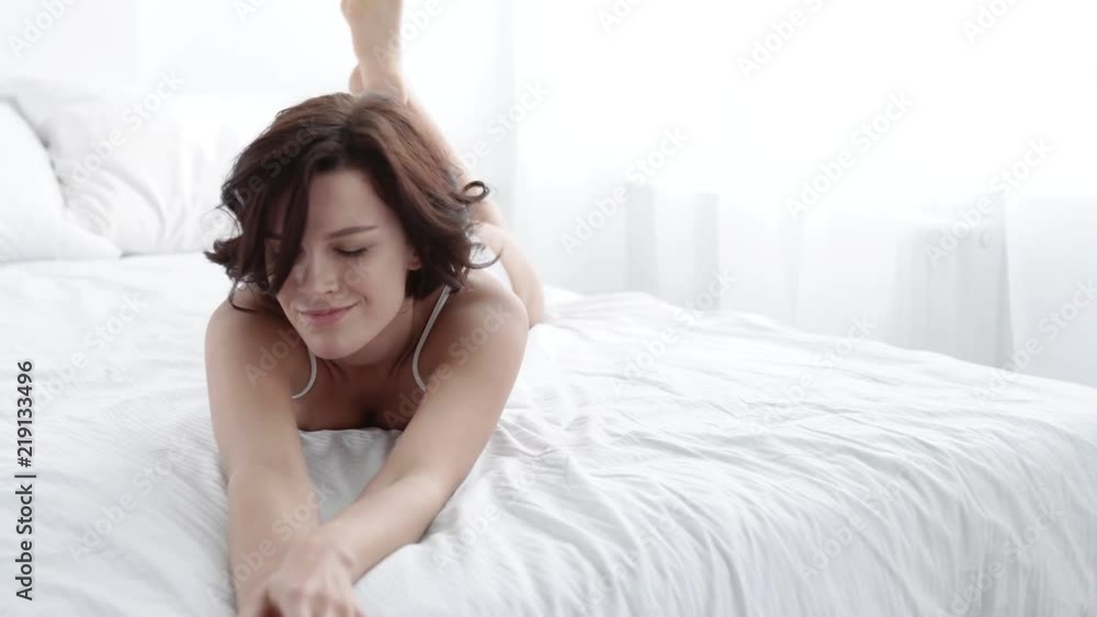 Health And Beauty. Beautiful Smiling Woman Lying On White Bed Health And Beauty. Beautiful Smiling Woman Lying On White Bed