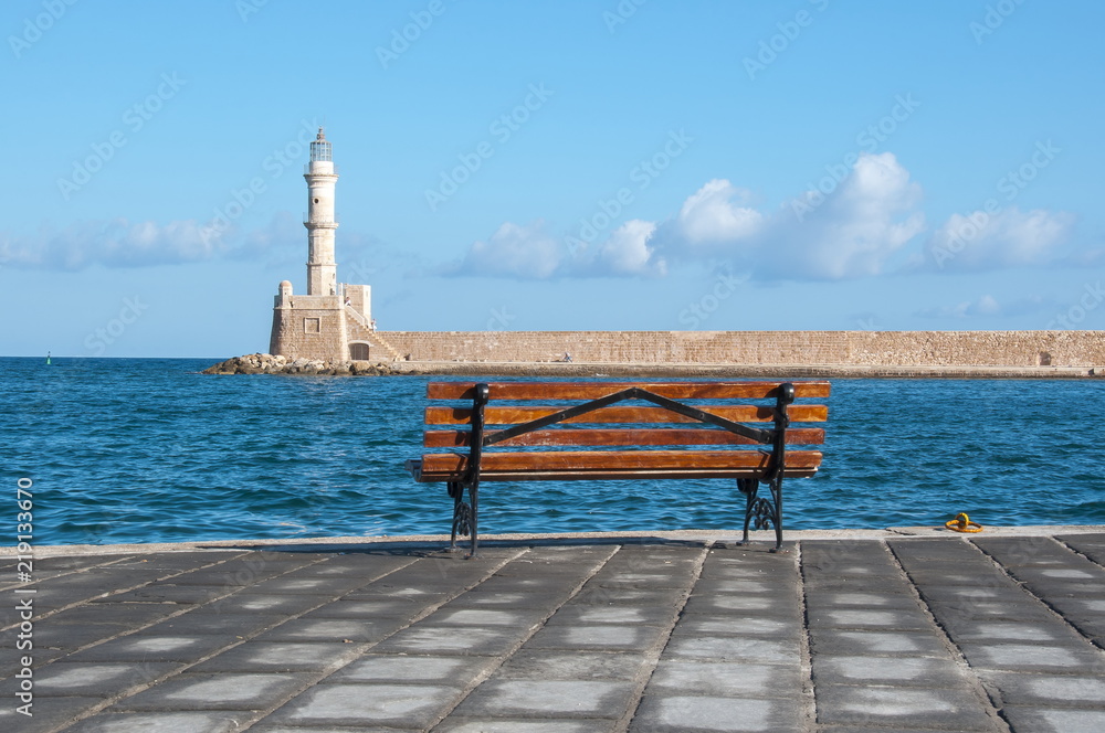 Chania beacon and bench on promenade at sea, Crete, Greece