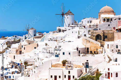 View of the village of Oia, Santorini, Greece, Europe. Beautiful classical white Greek architecture with windmills on the volcano of Santorini. Cycladic island of Caldera, the Aegean Sea in Greece.