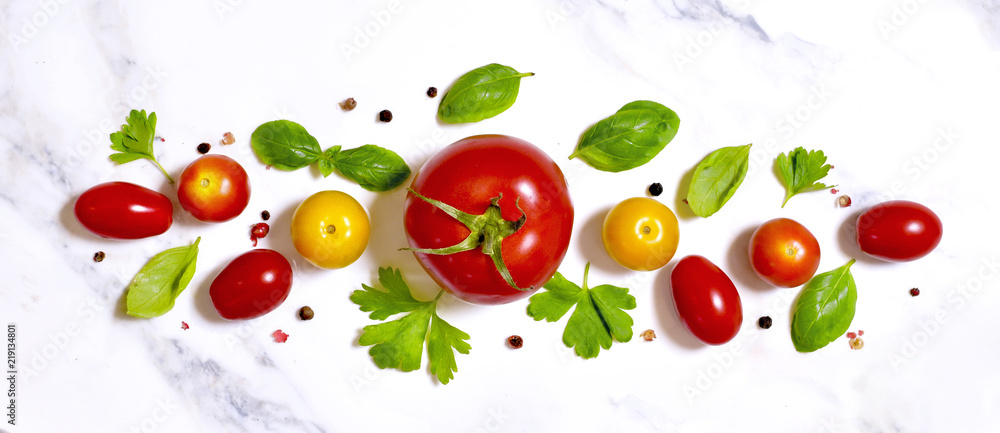 Delicious fresh tomatoes on a white marble stone background. Top view with copy space. Delicious fresh tomatoes on a white marble stone background. Top view with copy space.