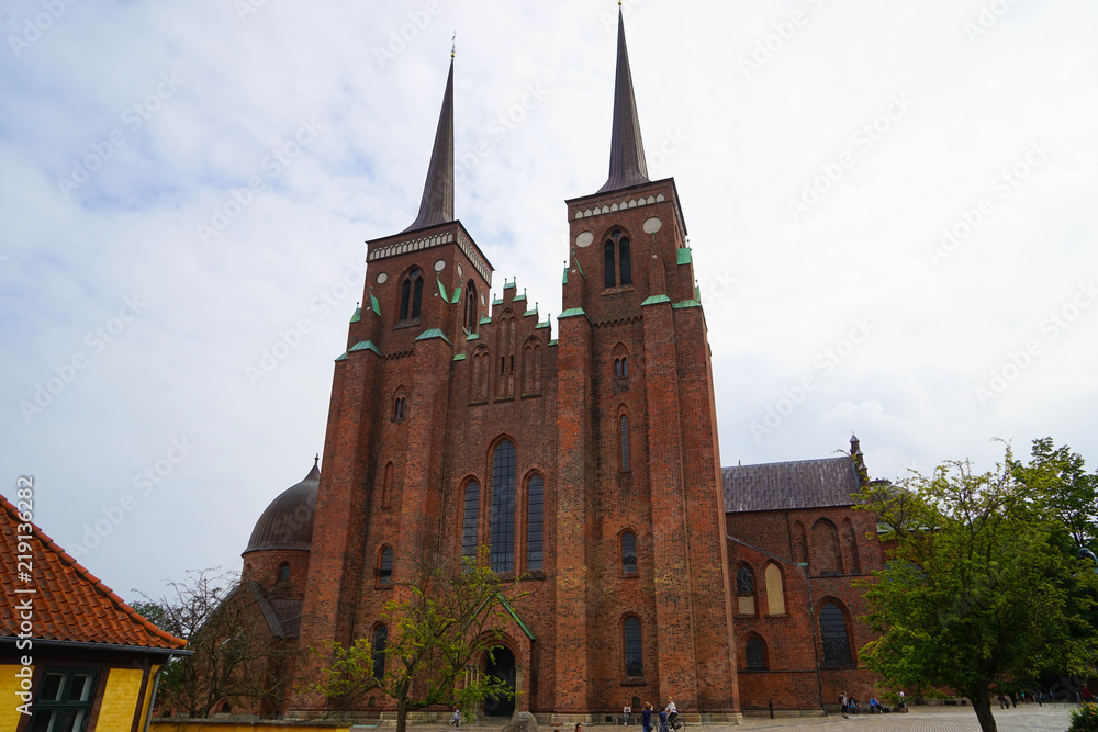 Fototapeta premium Roskilde Cathedral is a cathedral of the Lutheran Church of Denmark. The first Gothic cathedral to be built of brick, it encouraged the spread of the Brick Gothic style throughout Northern Europe