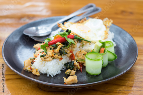 Fried pork with basil and egg on rice.