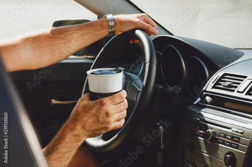 traveling on the road, drinks and people in the car with cups of coffee