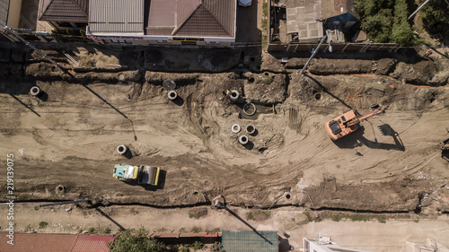 Aerial construction site with machinery. Top down view of city building site.
